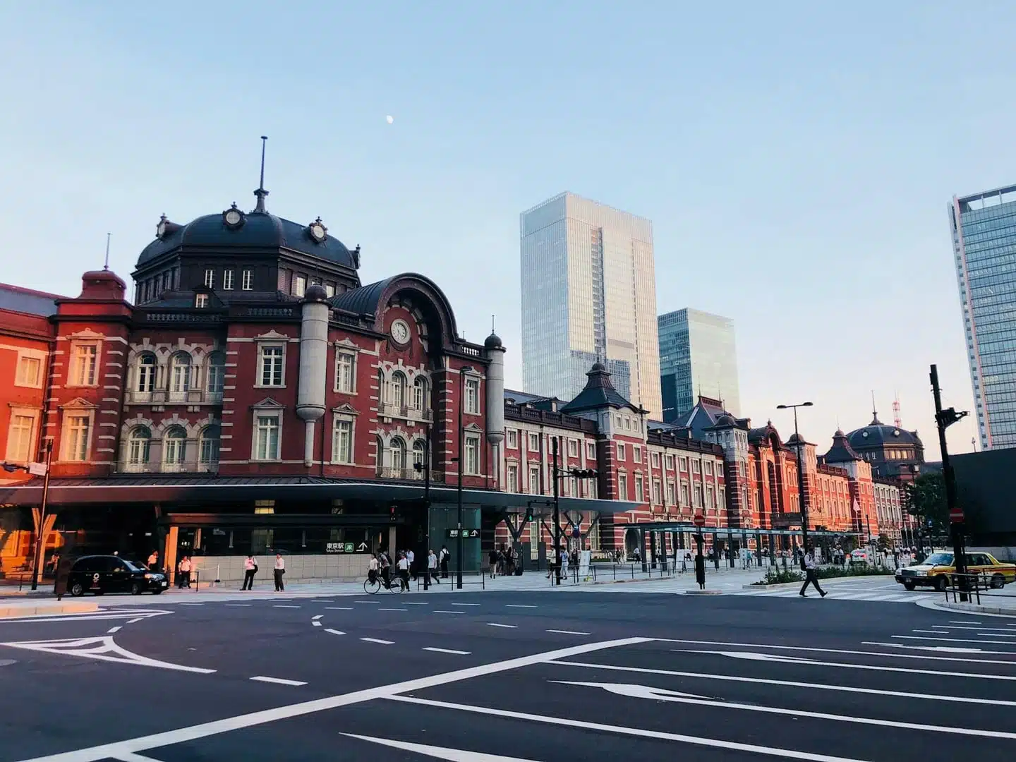 A beautiful view of Tokyo Station in Chiyoda City, with its historic architecture and modern skyline at dusk.