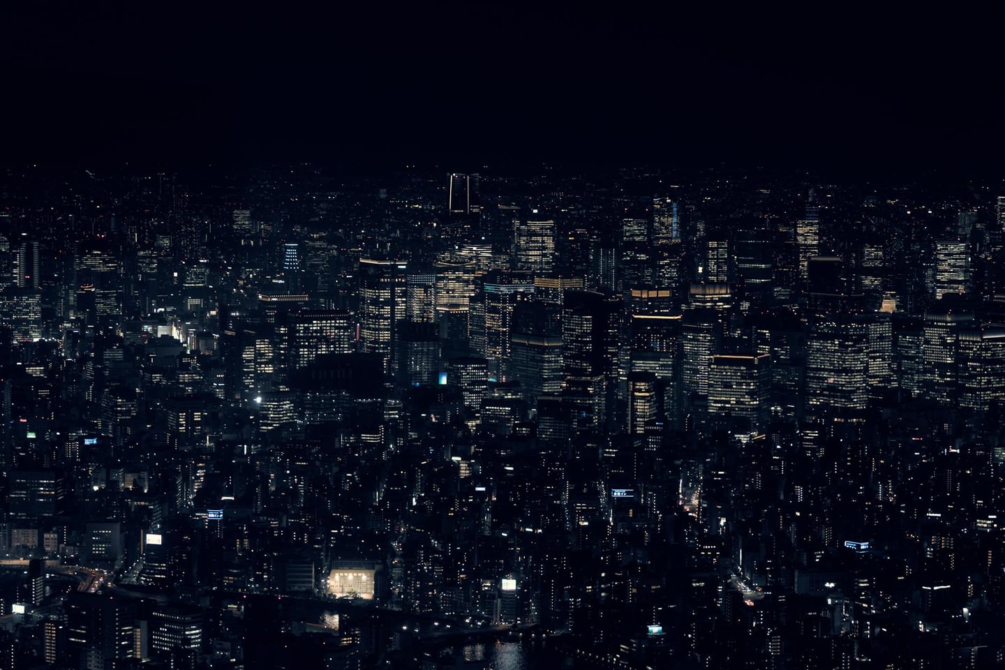 A stunning view of Tokyo's cityscape with illuminated skyscrapers at night, showcasing urban life in Japan.