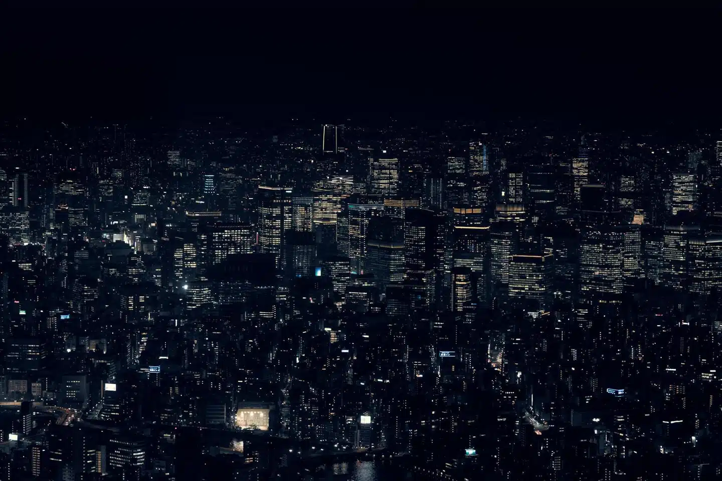 A stunning view of Tokyo's cityscape with illuminated skyscrapers at night, showcasing urban life in Japan.