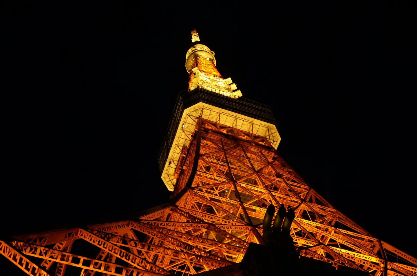 A striking night view of Tokyo Tower glowing brightly in Tokyo, Japan.