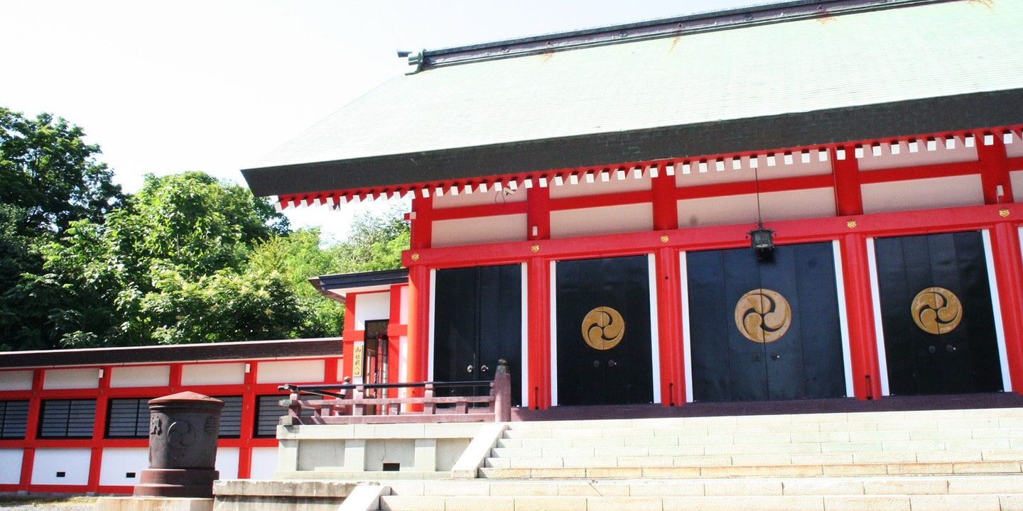 小樽住吉神社朱紅色社殿外觀與金色三巴神紋門扉