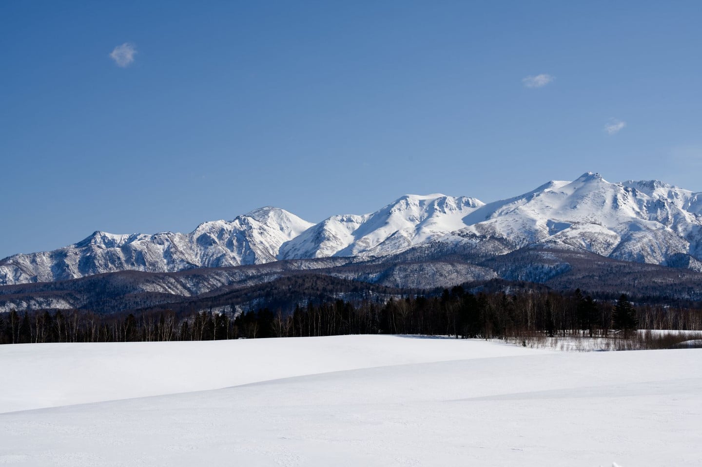 Breathtaking view of snow-capped mountains in Hokkaido, Japan during winter.