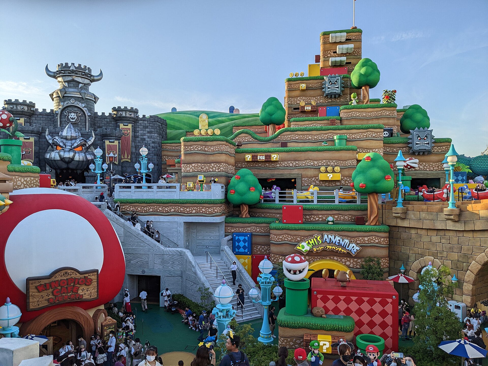 Colorful Super Nintendo World area at Universal Studios Japan with castle, Mario-themed blocks, and crowds